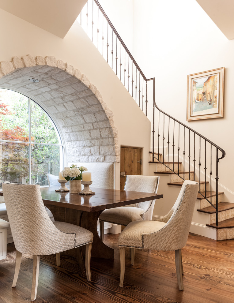 Mediterranean dining room in Other with beige walls and dark hardwood flooring.