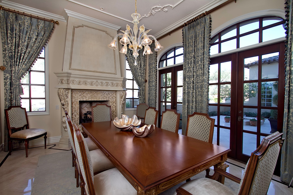 Enclosed dining room - large traditional marble floor and brown floor enclosed dining room idea in Phoenix with beige walls, a standard fireplace and a wood fireplace surround