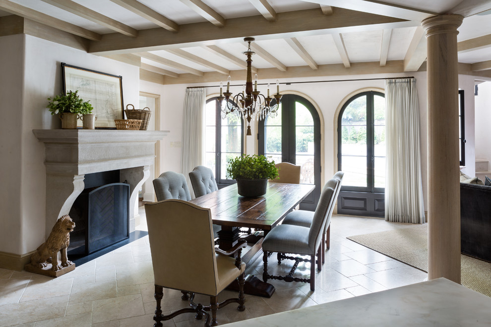 Enclosed dining room - large mediterranean medium tone wood floor enclosed dining room idea in DC Metro with beige walls, a standard fireplace and a stone fireplace
