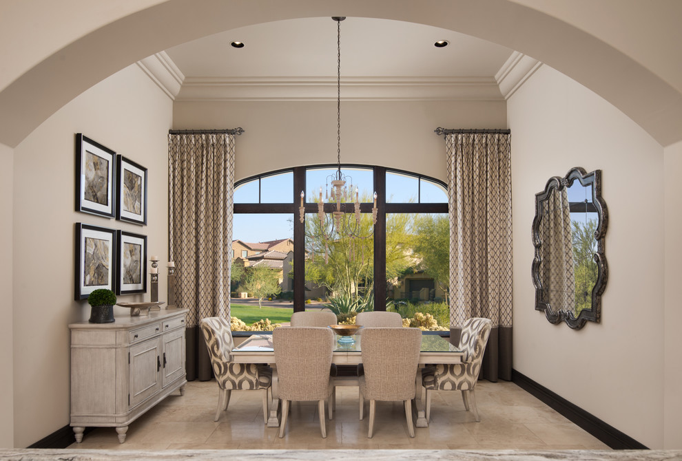 This is an example of an expansive mediterranean kitchen/dining room in Phoenix with beige walls, travertine flooring, a standard fireplace, a stone fireplace surround and beige floors.