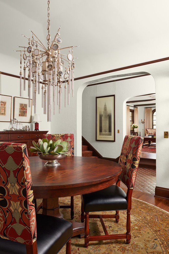 Dining room - mediterranean medium tone wood floor and brown floor dining room idea in Minneapolis with white walls