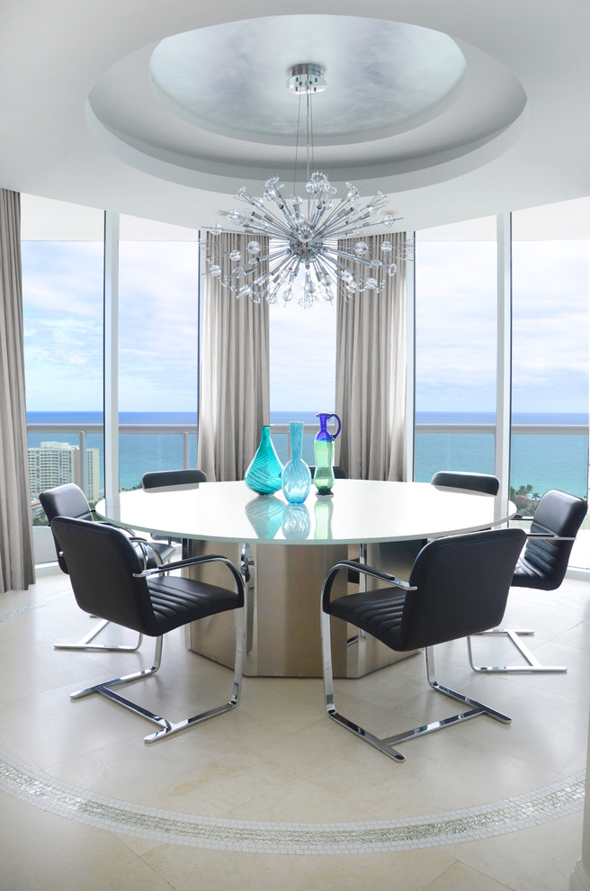 This is an example of a contemporary open plan dining room in Miami with limestone flooring and beige floors.