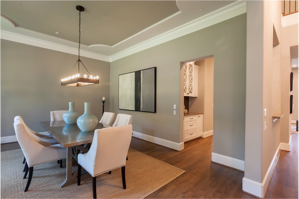 Inspiration for a large traditional enclosed dining room in Houston with grey walls and medium hardwood flooring.