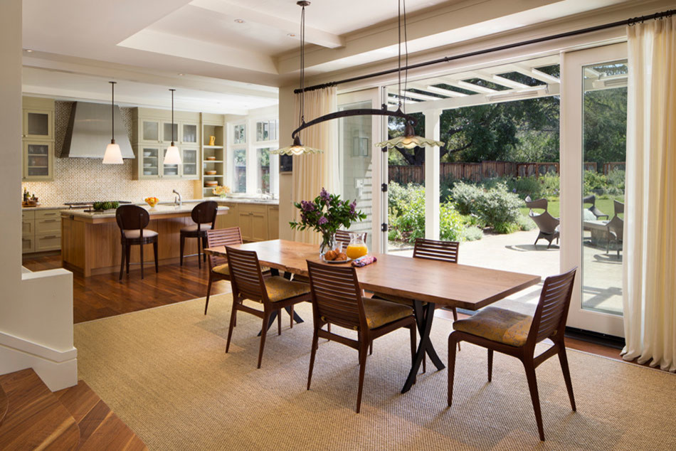 This is an example of a medium sized contemporary kitchen/dining room in San Francisco with white walls, medium hardwood flooring and no fireplace.