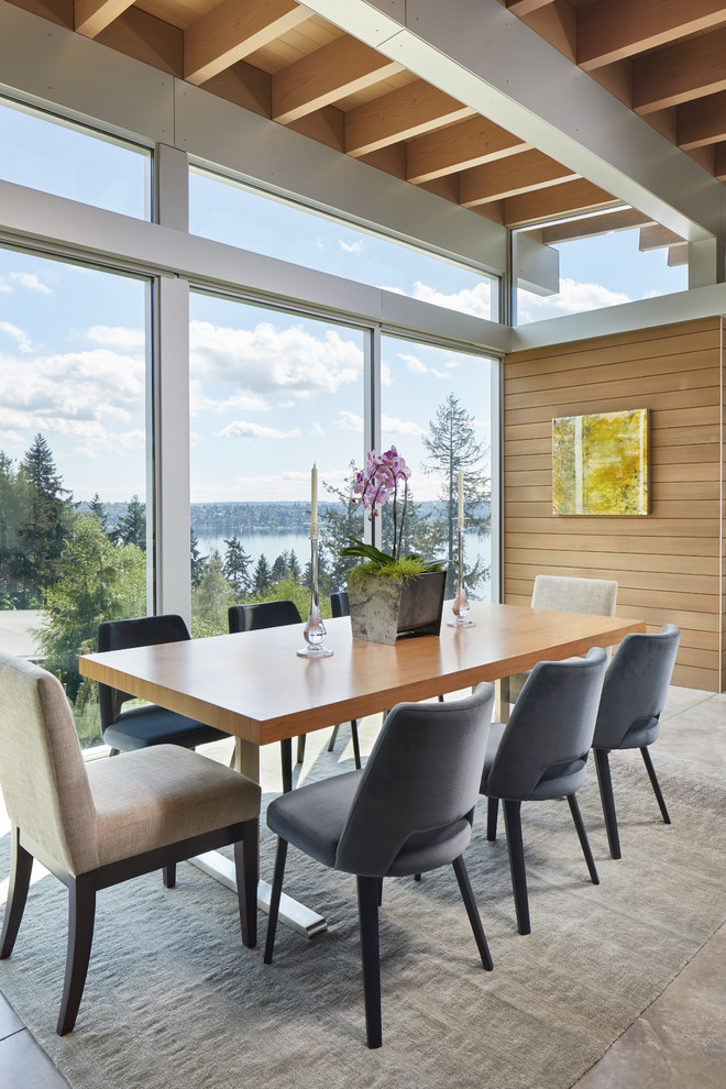 Expansive modern open plan dining room in Seattle with concrete flooring and grey floors.