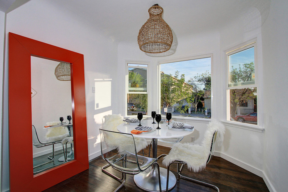 Trendy dark wood floor dining room photo in Los Angeles with white walls