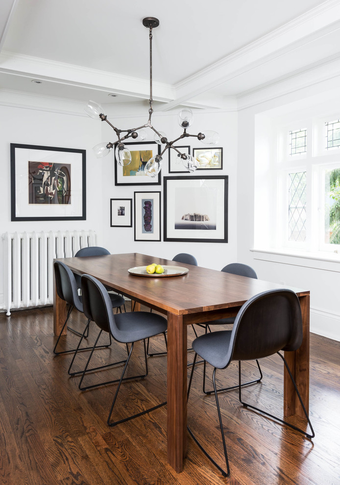 Contemporary dining room in Toronto with white walls and dark hardwood flooring.