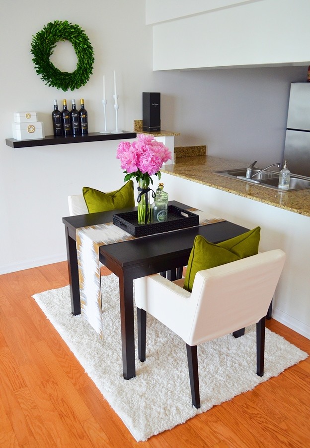 Photo of a small modern kitchen/dining room in Miami with white walls, light hardwood flooring and no fireplace.