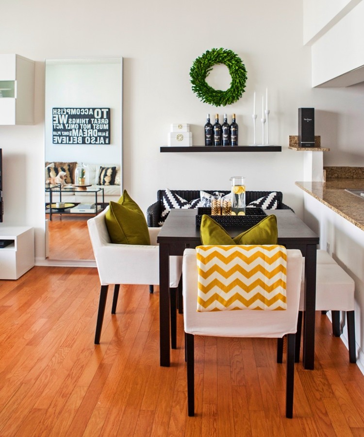 Inspiration for a small modern kitchen/dining room in Miami with white walls, light hardwood flooring and no fireplace.