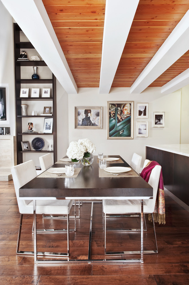 This is an example of a contemporary dining room in Chicago with white walls and dark hardwood flooring.
