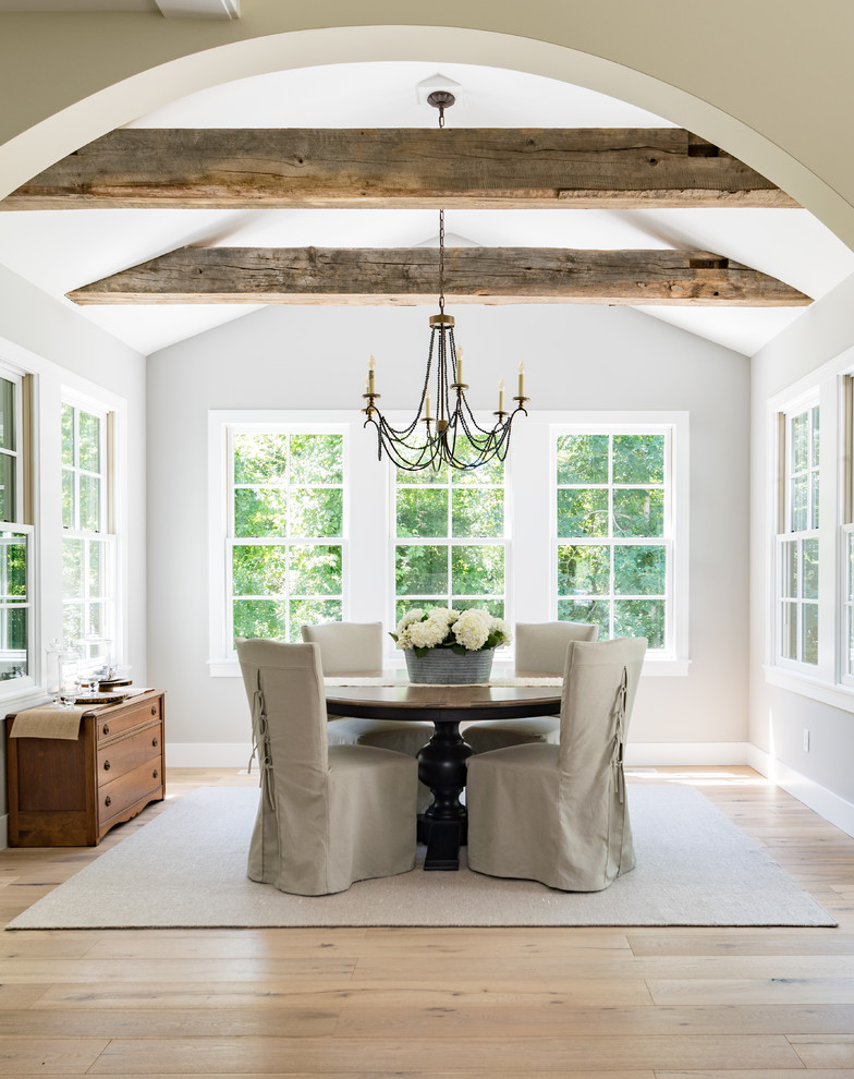 Inspiration for a traditional enclosed dining room in Grand Rapids with grey walls and light hardwood flooring.