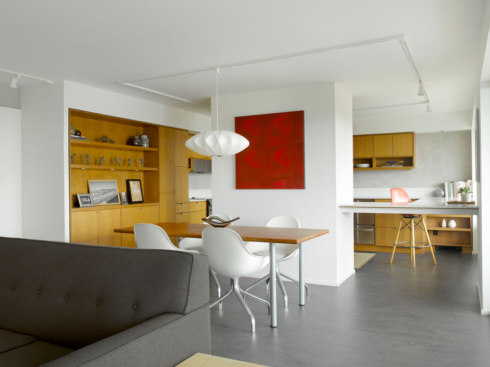 Dining room - 1960s concrete floor dining room idea in Seattle