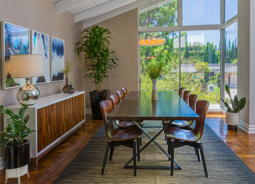 Photo of a midcentury dining room in Los Angeles with beige walls, medium hardwood flooring and feature lighting.