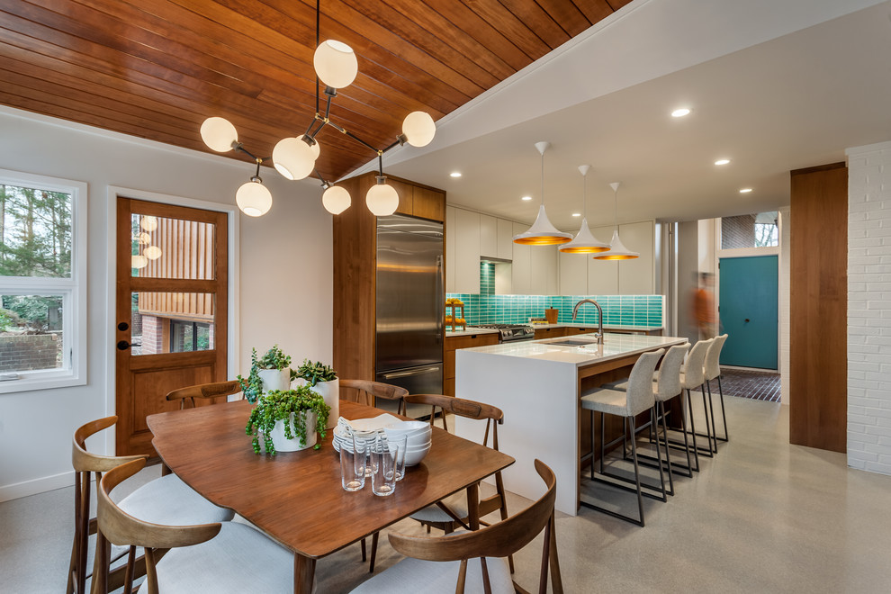 Esempio di una sala da pranzo aperta verso la cucina moderna con pareti bianche e pavimento grigio