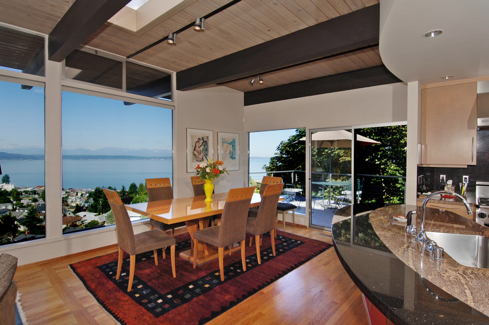 Photo of a medium sized modern dining room in Seattle with white walls, light hardwood flooring and no fireplace.