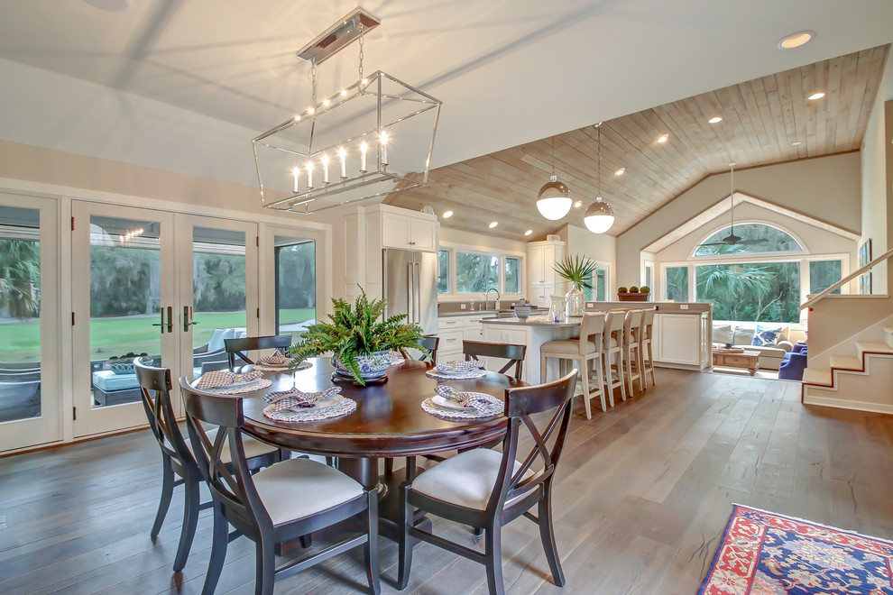 Mid-sized transitional medium tone wood floor and brown floor kitchen/dining room combo photo in Jacksonville with gray walls and no fireplace