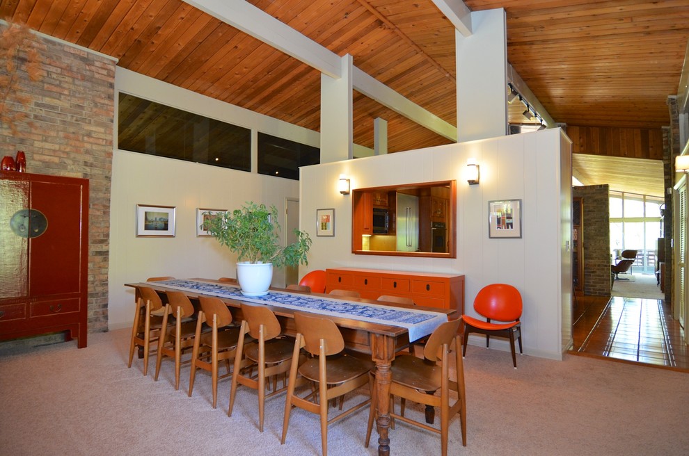 This is an example of a midcentury dining room in Other.