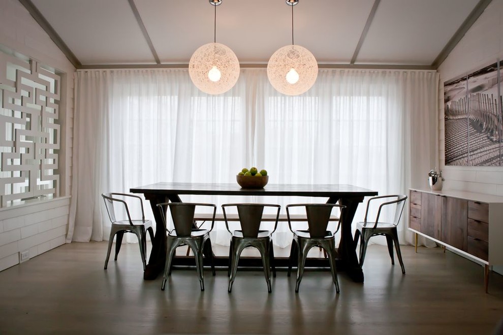 This is an example of a midcentury dining room in Boston with white walls.
