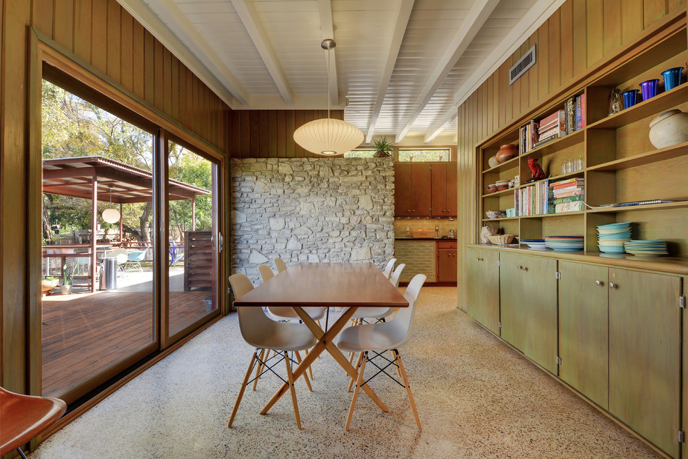 Design ideas for a midcentury dining room in Austin with brown walls.