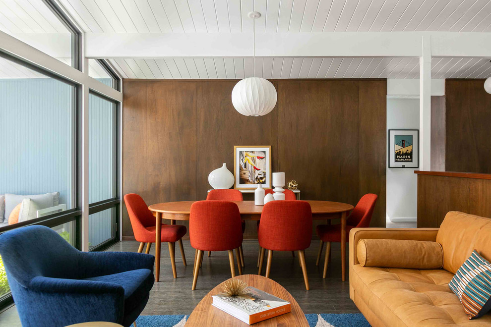 Example of a mid-century modern brown floor and dark wood floor great room design in San Francisco with brown walls and no fireplace