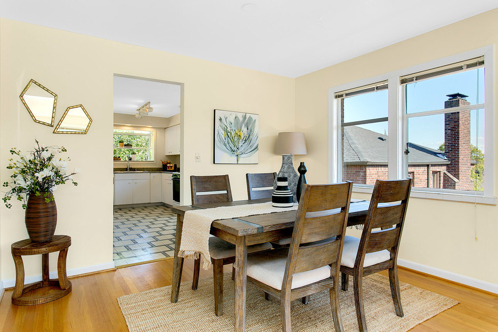 Medium sized midcentury enclosed dining room in Seattle with beige walls, medium hardwood flooring and no fireplace.