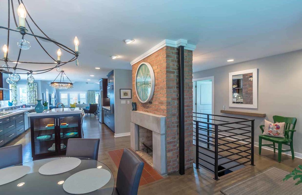 This is an example of a large contemporary kitchen/dining room in Chicago with grey walls, medium hardwood flooring, a standard fireplace, a brick fireplace surround, brown floors, a wallpapered ceiling, wallpapered walls and feature lighting.