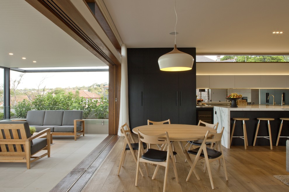 Inspiration for a contemporary open plan dining room in Sydney with light hardwood flooring and beige floors.