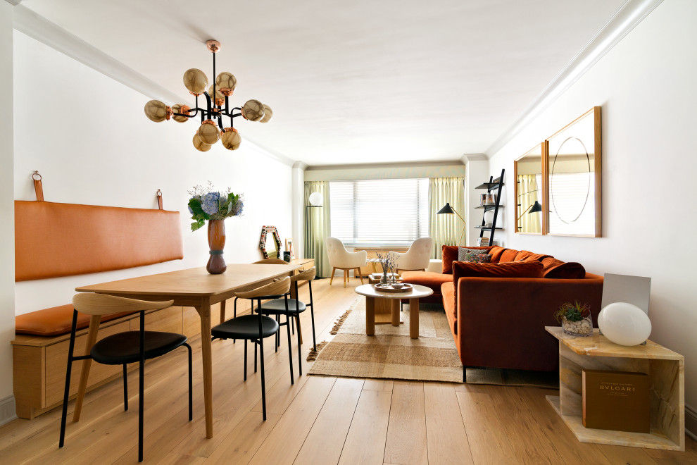 Inspiration for a contemporary medium tone wood floor and brown floor great room remodel in New York with white walls