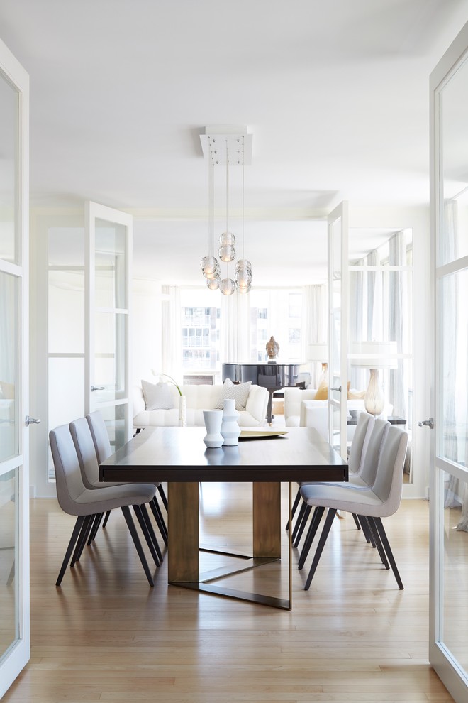 Photo of a classic enclosed dining room in Other with light hardwood flooring and beige floors.