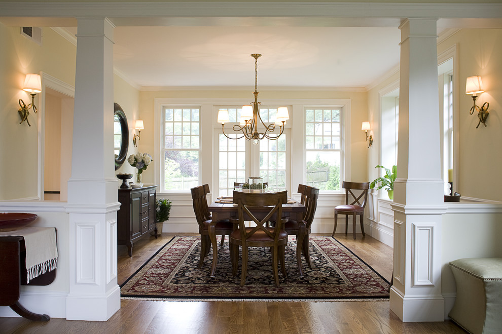 Inspiration for a traditional dining room in Boston with beige walls, medium hardwood flooring and a dado rail.