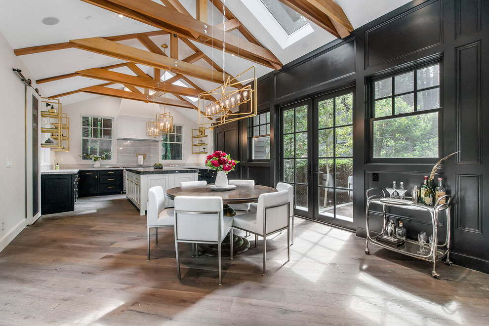 Example of a mid-sized transitional dark wood floor and gray floor kitchen/dining room combo design in San Francisco with black walls and no fireplace