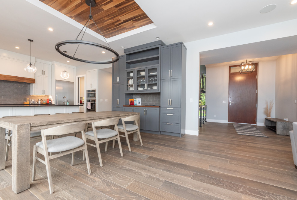 Mid-sized transitional dark wood floor and brown floor kitchen/dining room combo photo in Minneapolis with gray walls