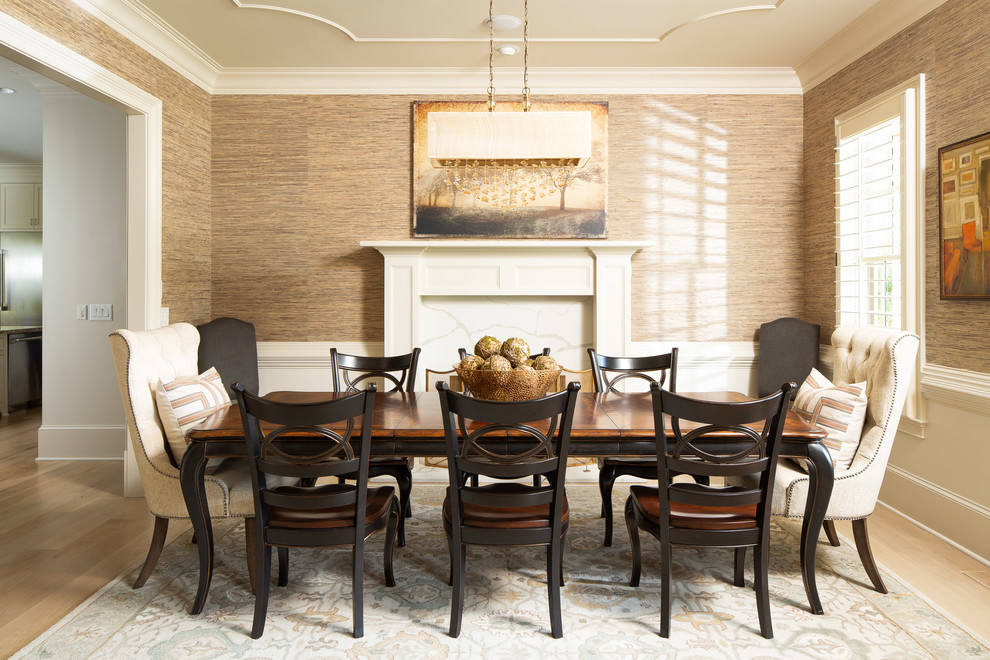 This is an example of a medium sized country enclosed dining room in Atlanta with brown walls, light hardwood flooring, a standard fireplace, beige floors and a tiled fireplace surround.
