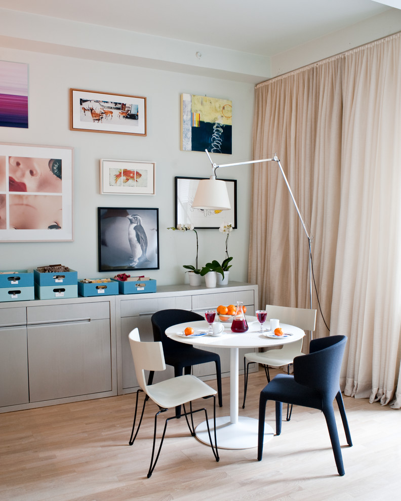 Small trendy light wood floor and beige floor dining room photo in New York with white walls