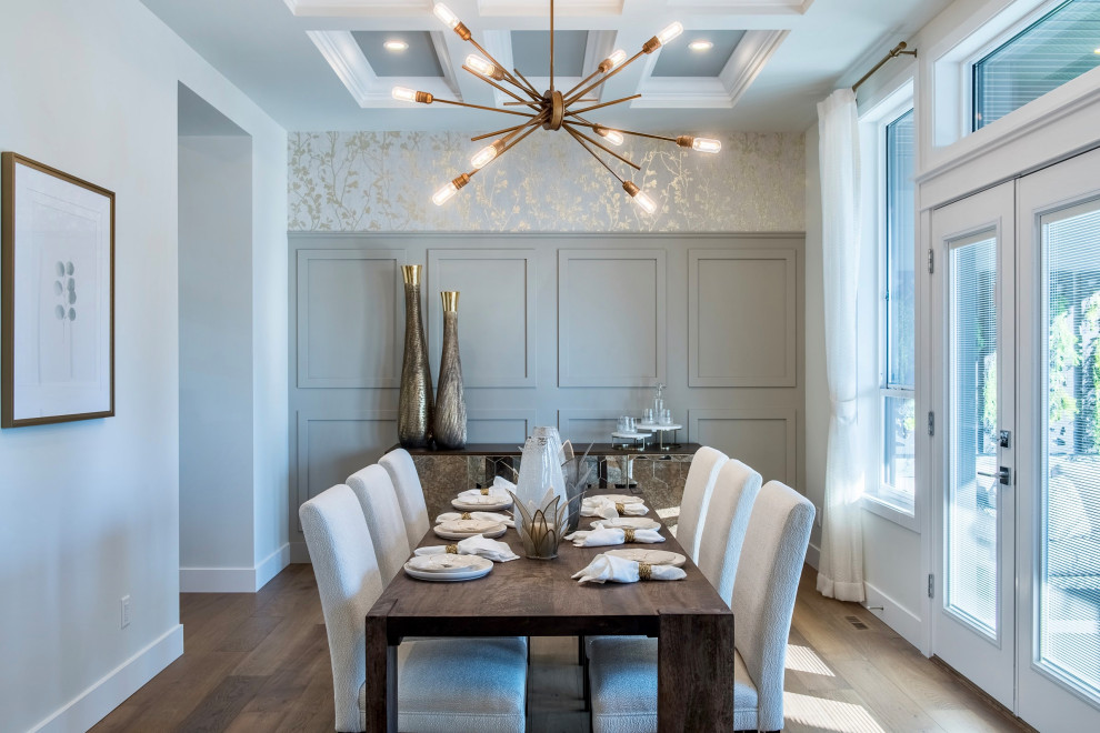 Photo of a large traditional enclosed dining room in Vancouver with medium hardwood flooring, no fireplace, brown floors, a coffered ceiling and wainscoting.