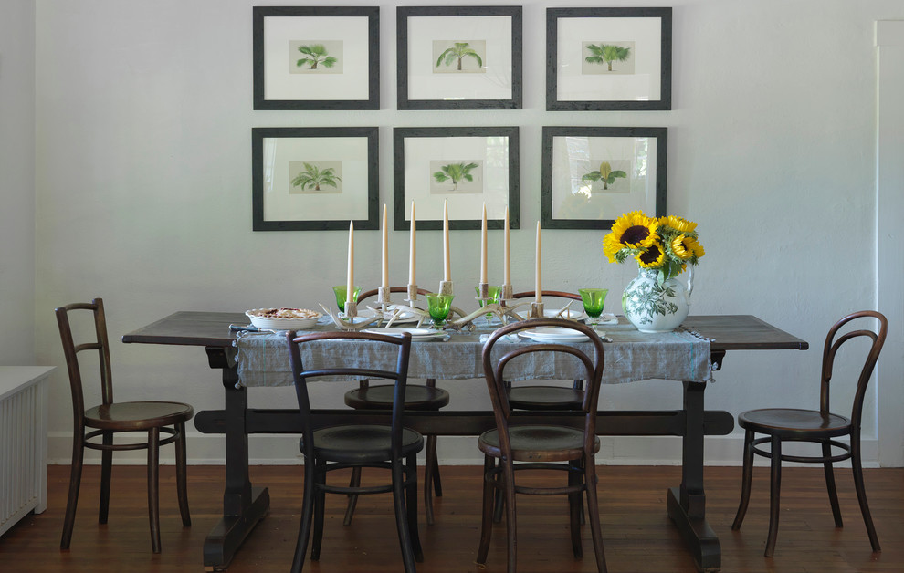 Country dining room in Providence with white walls and dark hardwood flooring.