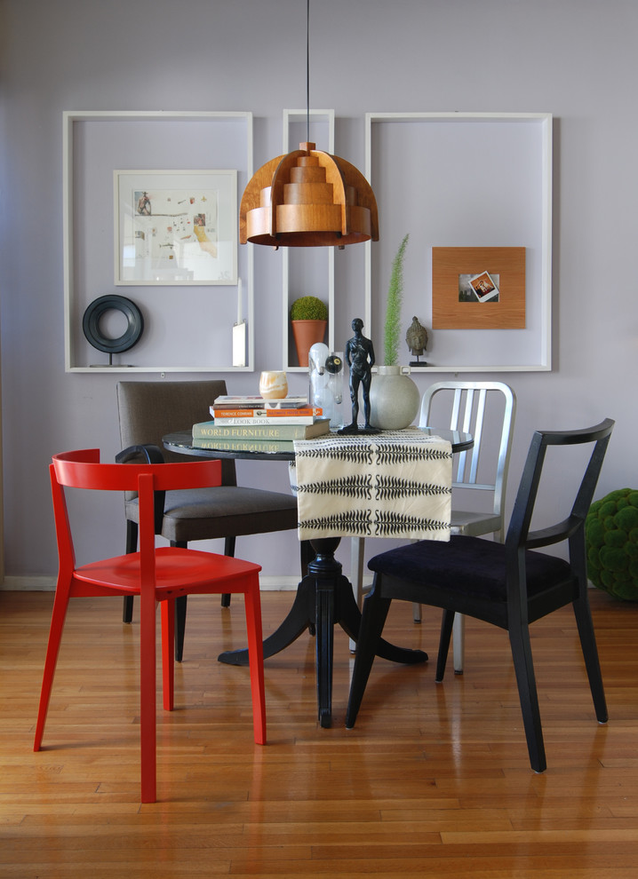 Example of an eclectic medium tone wood floor dining room design in Los Angeles with gray walls
