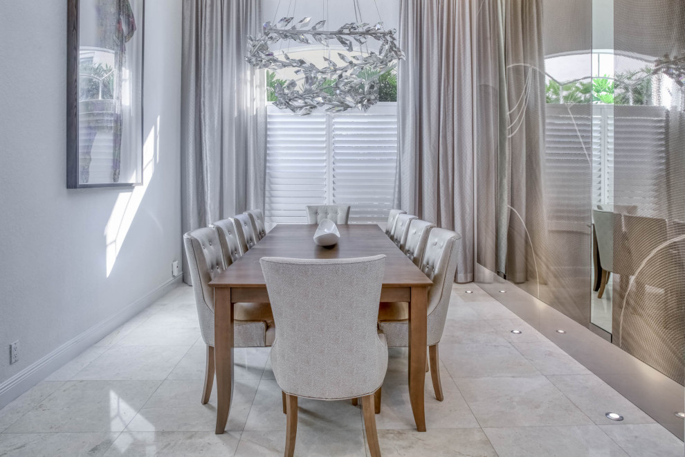 Medium sized modern enclosed dining room in Miami with grey walls, ceramic flooring and grey floors.