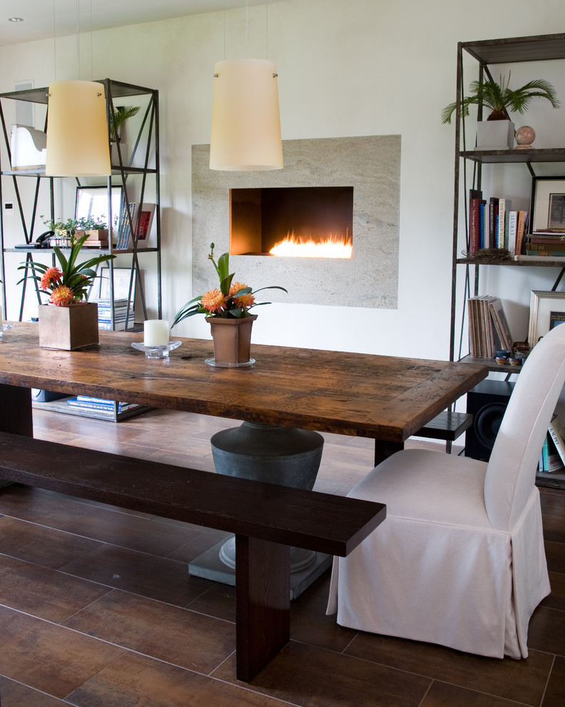 Inspiration for a transitional dining room remodel in New York with white walls and a ribbon fireplace