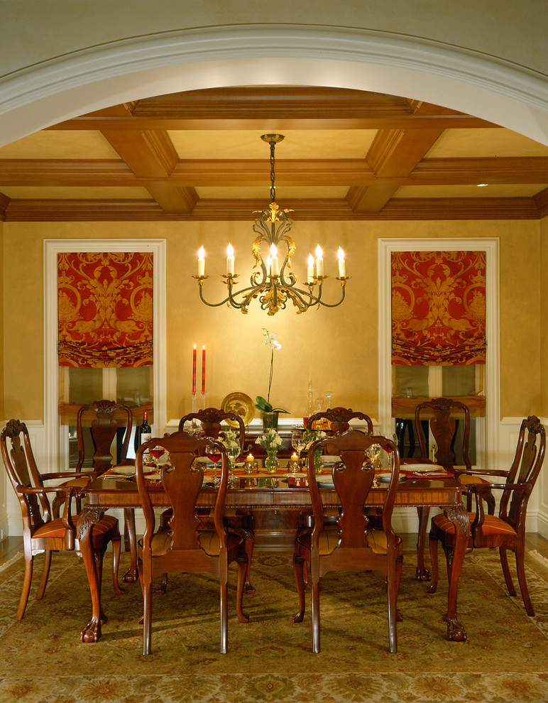 Traditional dining room in San Francisco with yellow walls and medium hardwood flooring.