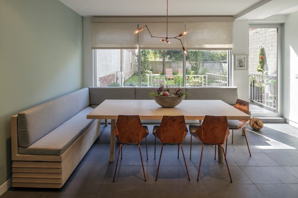 Photo of a large modern kitchen/dining room in New York with blue walls, ceramic flooring and no fireplace.