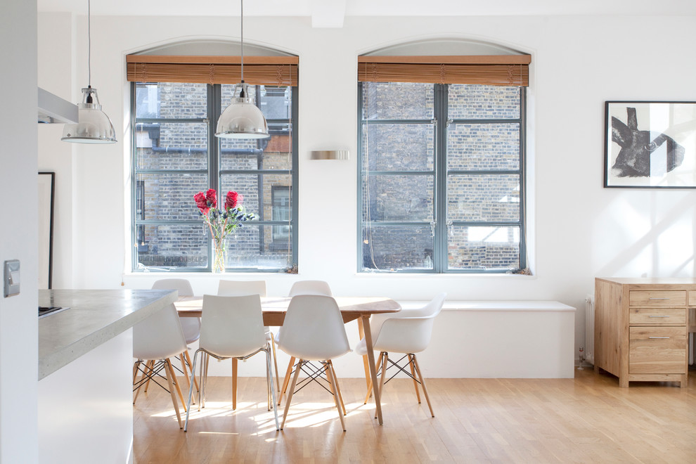 Minimalist dining room photo in London with white walls