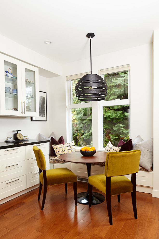 This is an example of a small classic kitchen/dining room in Vancouver with white walls, dark hardwood flooring, no fireplace and brown floors.