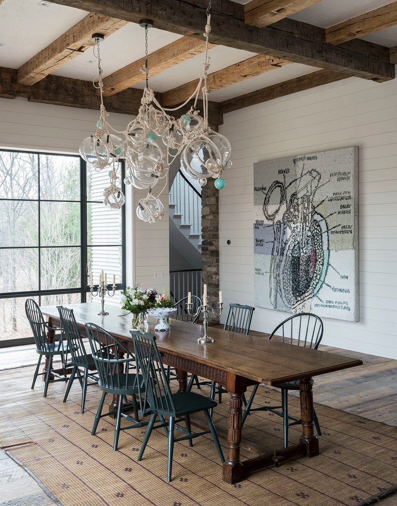 Traditional dining room in Boston with white walls, medium hardwood flooring and no fireplace.