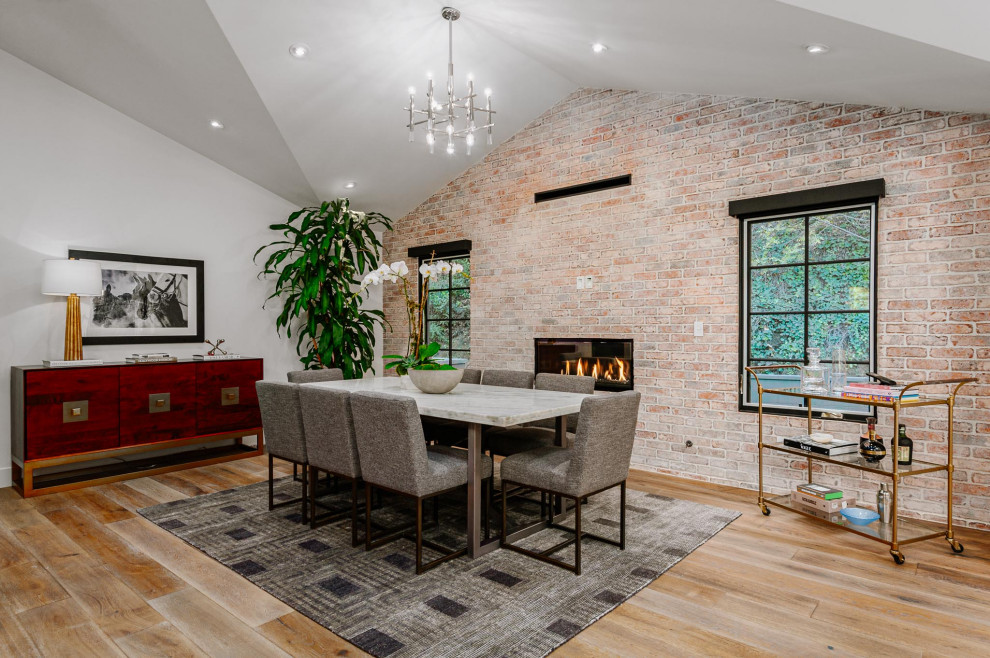 Great room - large cottage medium tone wood floor great room idea in Los Angeles with red walls, a ribbon fireplace and a brick fireplace