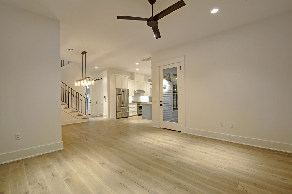 Example of a mid-sized farmhouse laminate floor and beige floor kitchen/dining room combo design in Austin with white walls
