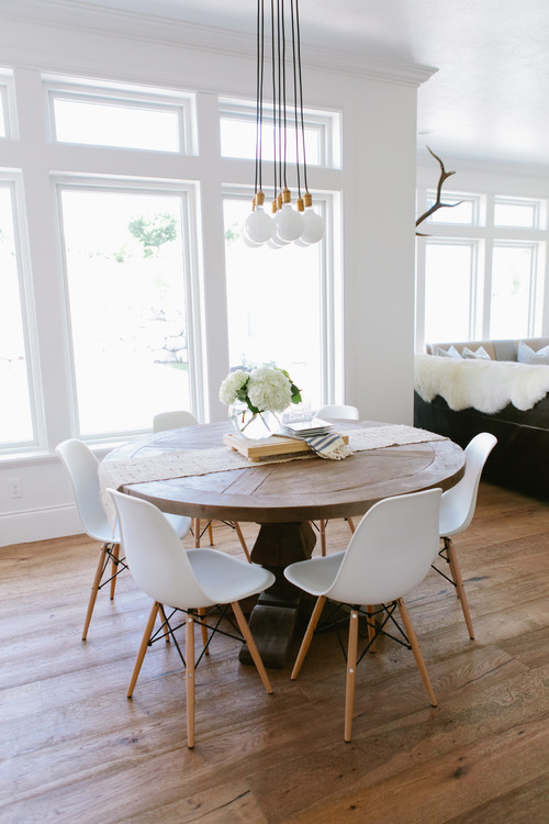  farmhouse medium tone wood floor great room design in Salt Lake City with white walls || 10 Tips for Decorating a Dining Room on a Small Budget