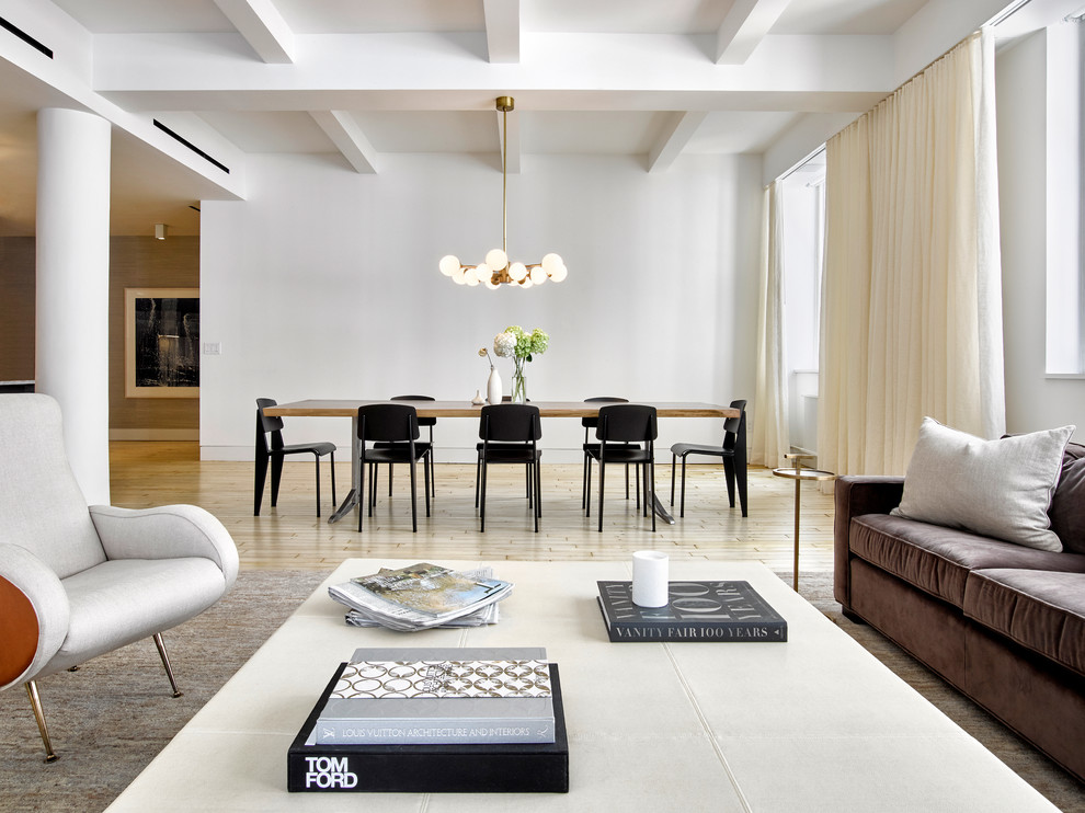 Photo of a large contemporary open plan dining room in New York with white walls and light hardwood flooring.