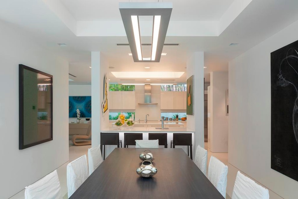 Large contemporary kitchen/dining room in Miami with white walls and porcelain flooring.