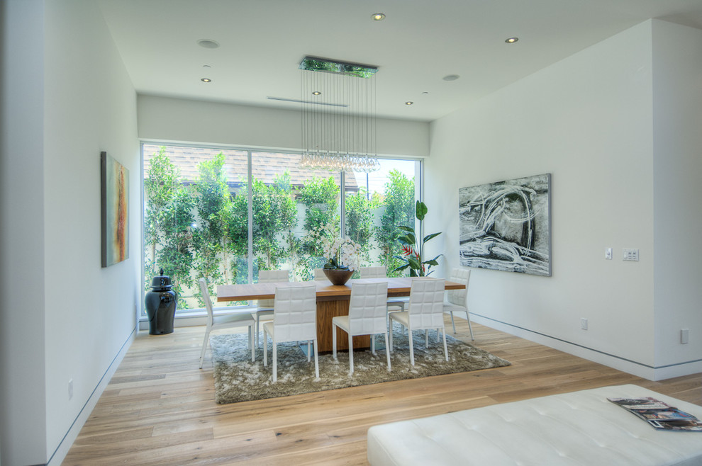 Photo of a large contemporary open plan dining room in Los Angeles with white walls, light hardwood flooring and no fireplace.